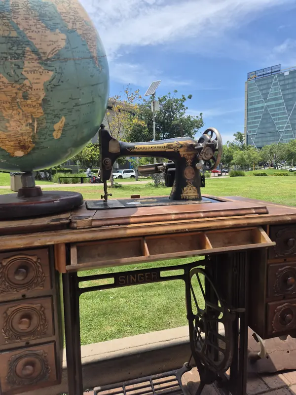 Antique Singer sewing machine and globe on display